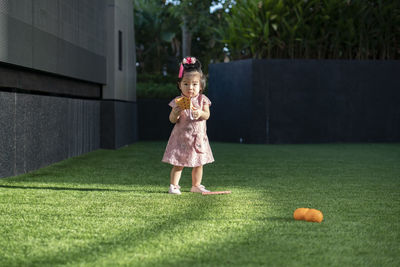 Full length of a girl standing on grass