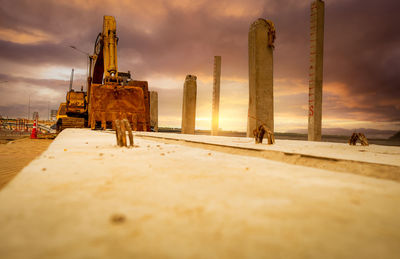 Selective focus on bucklet of old backhoe. digger parked at construction site. bulldozer near pole