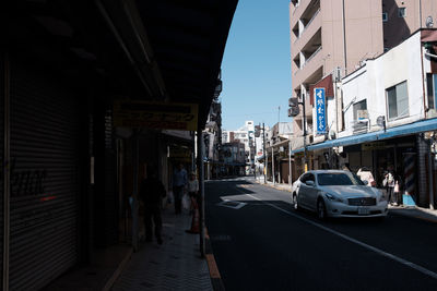 Vehicles on road along buildings