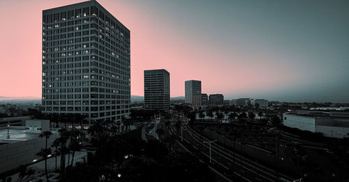 High angle view of buildings in city against sky during sunset