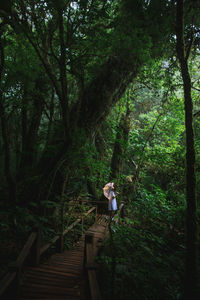 Rear view of woman walking in forest