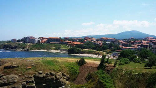 Scenic view of sea and buildings against sky