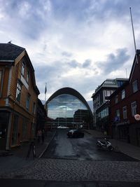 Street amidst buildings against sky in city