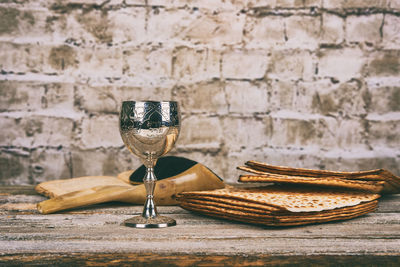 High angle view of wine with crackers and book on wooden table