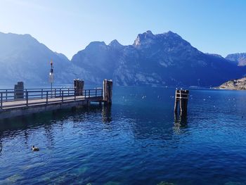 Scenic view of lake and mountains against blue sky