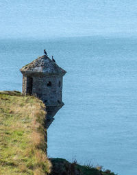 Building by sea against sky