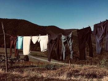 Clothes drying on clothesline against sky