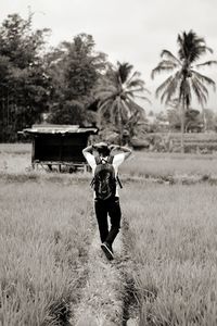 Full length of man standing on field against sky