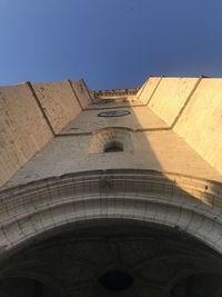 Low angle view of building against clear blue sky