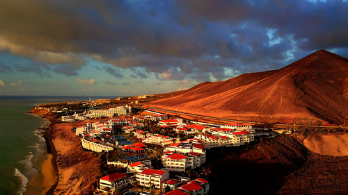 High angle view of buildings against cloudy sky