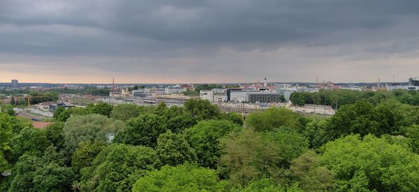 Panoramic view of trees and buildings against sky