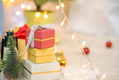 New year gift box with lighting on christmas tree background