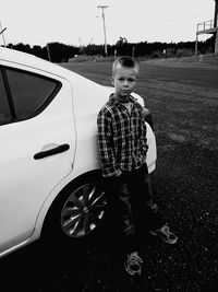 Boy standing in car