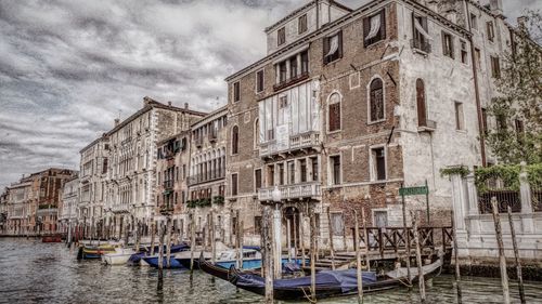 Boats in canal with buildings in background