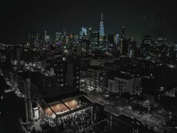 High angle view of city lit up at night