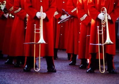 Low section of army soldiers wearing red uniform during parade