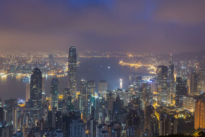 Illuminated cityscape against sky at night