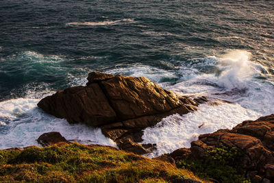 Scenic view of rocks on sea shore
