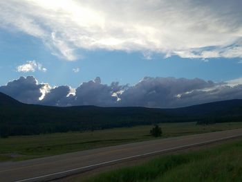 Scenic view of landscape against cloudy sky