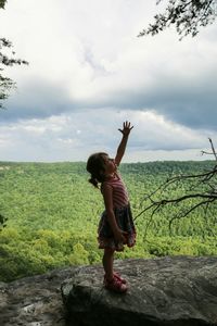 Full length of woman standing on field against sky