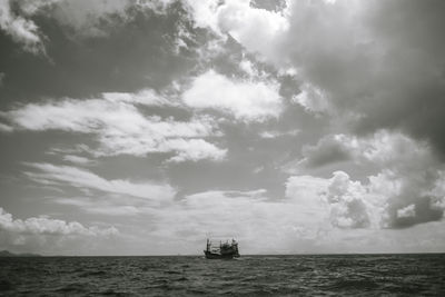 Boat sailing in sea against sky