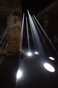 Low angle view of illuminated lights at night