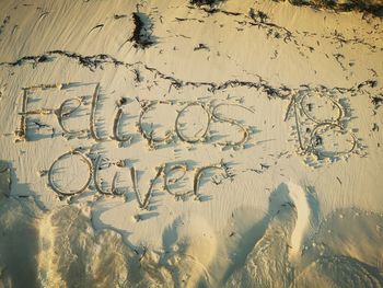 High angle view of text on beach