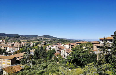 High angle view of townscape against clear blue sky