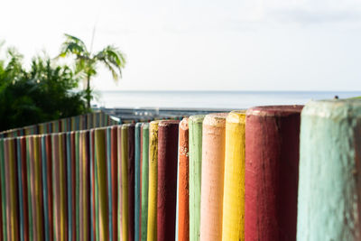 Colored fence with ocean in background 