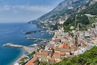 High angle view of townscape by sea against sky