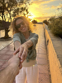 Portrait of young woman standing on pier