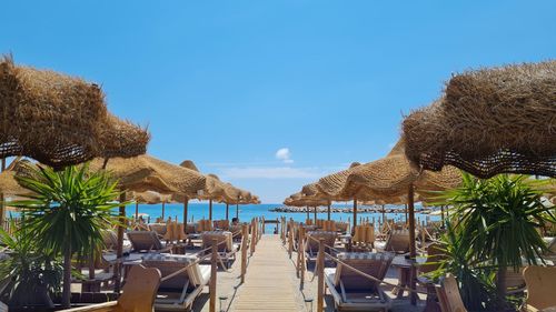 Panoramic view of lounge chairs at beach