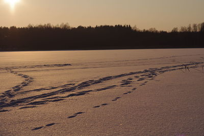 Scenic view of snow covered landscape against sky