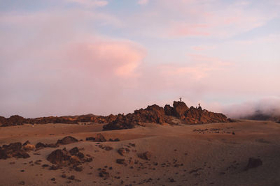 Scenic view of desert against sky during sunset