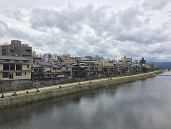 View of buildings in city against cloudy sky