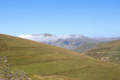 Scenic view of mountains against clear blue sky