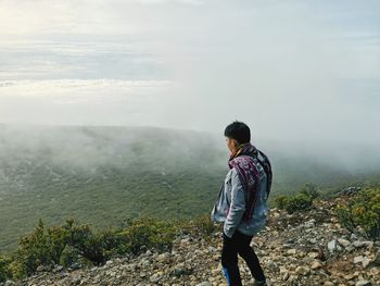 Rear view of man standing on mountain