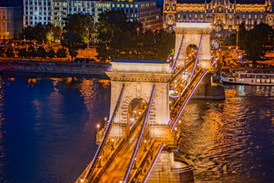 High angle view of illuminated bridge over river in city