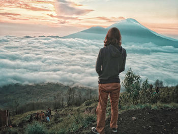 Rear view of man standing on mountain