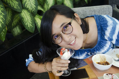 Portrait of a smiling young woman eating food