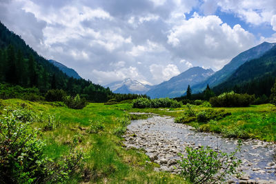 Scenic view of lake and mountains against sky