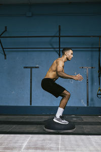 A male african american athlete exercising at gym