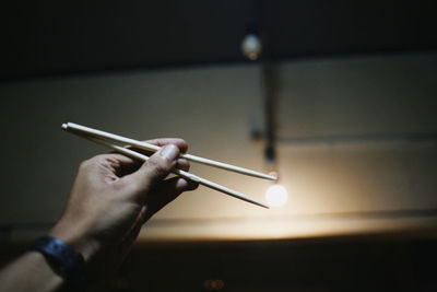 Close-up of hand holding chopsticks