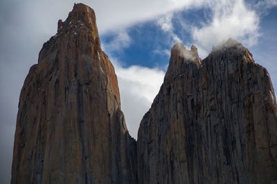 Low angle view of rock formations against sky