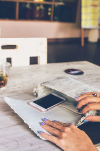 Close-up of woman reading book at home