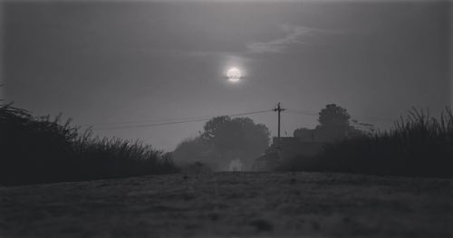 Surface level of silhouette landscape against bright sun