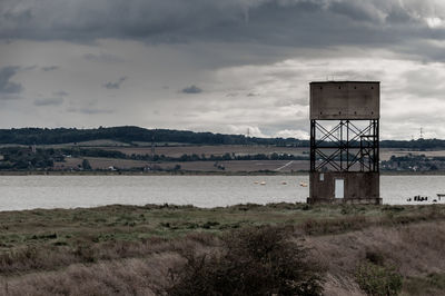 Built structure on field against sky