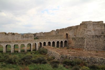 Old ruins of building against cloudy sky