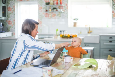 Women sitting on table at home