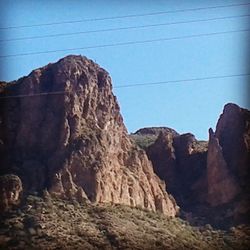 Low angle view of rocky mountains against sky